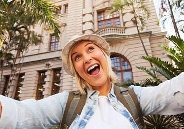 funny tourist taking selfie in front of historical building